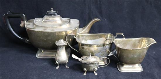 A 1930s silver three piece tea set and a silver mustard and pepper, gross 36 oz.